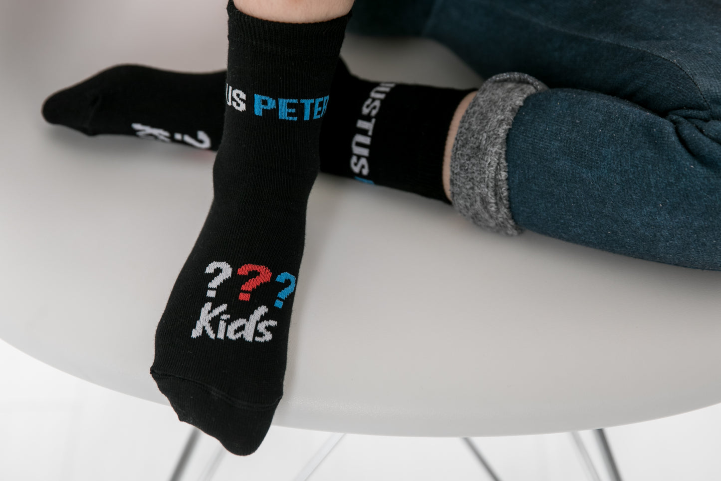 Ein Kind trägt die schwarzen die Drei ??? Kids Socken.